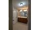 Bathroom features a double vanity, tile floor, and large mirror with decorative sconces at 5715 Radford Loop # 15, Fairburn, GA 30213