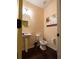 Small powder room featuring pedestal sink, low flow toilet, and decorative painting on wall at 5715 Radford Loop # 15, Fairburn, GA 30213