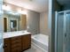 Bathroom with a soaking tub, glass-enclosed shower, and dual vanity with large mirror at 5715 Radford Loop # 15, Fairburn, GA 30213