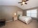 Neutral bedroom features a ceiling fan, window, and a bed with decorative headboard at 5715 Radford Loop # 15, Fairburn, GA 30213