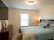 Comfortable bedroom featuring a large bed, wood dresser and a window letting in lots of natural light at 5715 Radford Loop # 15, Fairburn, GA 30213