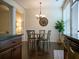 Bright dining area features modern light fixture, hard wood floors, and large window with adjustable blinds at 5715 Radford Loop # 15, Fairburn, GA 30213