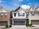 Charming two-story home with a two car garage, white siding, and well-maintained landscaping at 5715 Radford Loop # 15, Fairburn, GA 30213