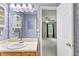 This bathroom has a decorative mirror, sink, and doorway to the bedroom at 98 Little John Way, Douglasville, GA 30134