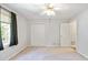 Bedroom with neutral walls and carpet, features a ceiling fan and closet with double doors at 98 Little John Way, Douglasville, GA 30134