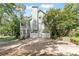 Home exterior featuring a two-car garage, side porch, and green surroundings at 98 Little John Way, Douglasville, GA 30134