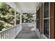Inviting porch featuring a comfortable porch swing and outdoor views at 98 Little John Way, Douglasville, GA 30134