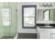 Bathroom featuring a glass-enclosed shower, stone tile flooring, and modern vanity at 1497 Rogers Ave, Atlanta, GA 30310