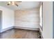 Bedroom with hardwood floors, whitewashed wood accent wall and natural light at 1497 Rogers Ave, Atlanta, GA 30310