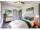 This staged bedroom includes an accent rug, lamps, and wall decor at 1497 Rogers Ave, Atlanta, GA 30310