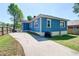 A blue home with a concrete driveway and fenced-in yard; ample parking and a sense of privacy at 1497 Rogers Ave, Atlanta, GA 30310