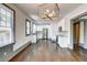Bright, open kitchen with white cabinets, stainless steel appliances, and hardwood floors at 1497 Rogers Ave, Atlanta, GA 30310
