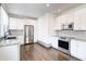 Contemporary kitchen featuring white cabinetry, granite countertops, and stainless steel appliances at 1497 Rogers Ave, Atlanta, GA 30310