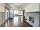 Open-concept living room with hardwood floors, a decorative fireplace, and abundant natural light at 1497 Rogers Ave, Atlanta, GA 30310