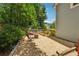 Cozy backyard with gravel patio, seating, fire pit, and wood fence in a private setting at 3450 Saddleton Way, Douglasville, GA 30134