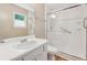 Bright bathroom features a single sink vanity and a glass door shower with grab bars for easy access at 3450 Saddleton Way, Douglasville, GA 30134