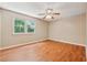 Bright bedroom with wood-look floors and a large window offering a view of the trees at 3450 Saddleton Way, Douglasville, GA 30134