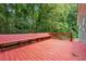 Relaxing wooden deck offers serene views of the lush, surrounding woodland area at 3450 Saddleton Way, Douglasville, GA 30134