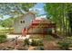 Charming home exterior with a multi-level deck and steps leading to a gravel patio at 3450 Saddleton Way, Douglasville, GA 30134
