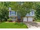 Charming two-story home featuring a blue exterior, landscaped yard, and two-car garage at 3450 Saddleton Way, Douglasville, GA 30134