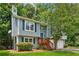 Charming two-story home with blue siding, a wooden porch, and a well-manicured front yard at 3450 Saddleton Way, Douglasville, GA 30134
