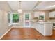 Bright eat-in kitchen with white cabinets, breakfast bar, and access to the backyard at 3450 Saddleton Way, Douglasville, GA 30134
