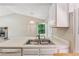 Well-lit eat-in kitchen area featuring a stone fireplace, white appliances and ample counterspace at 3450 Saddleton Way, Douglasville, GA 30134