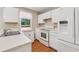 Well-equipped kitchen features white appliances, ample counter space, and a bright window at 3450 Saddleton Way, Douglasville, GA 30134