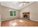 Inviting living room with a stone fireplace, vaulted ceilings, skylights, and wood-look floors at 3450 Saddleton Way, Douglasville, GA 30134