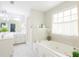 Bathroom featuring a soaking tub, a shower, double sinks, and modern fixtures at 3500 Parkwood Hills Ct, Snellville, GA 30078
