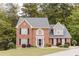 Charming two-story brick home with manicured lawn and traditional architectural details at 3500 Parkwood Hills Ct, Snellville, GA 30078