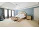 Comfortable main bedroom with natural light, ensuite bath, and plush carpet at 3500 Parkwood Hills Ct, Snellville, GA 30078