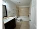 Neutral bathroom with ceramic tile, full tub, granite vanity, and updated fixtures at 40 Dunwoody Springs Dr, Atlanta, GA 30328