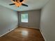 This bedroom features a ceiling fan, hardwood floors, neutral walls, and a bright window at 40 Dunwoody Springs Dr, Atlanta, GA 30328