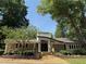 Community clubhouse surrounded by landscaping and mature trees at 40 Dunwoody Springs Dr, Atlanta, GA 30328