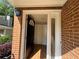 Townhome entryway featuring an open door, brick wall, and sidelight at 40 Dunwoody Springs Dr, Atlanta, GA 30328