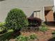 Landscaped front yard featuring mature trees and shrubs, retaining wall, and stacked stone at 40 Dunwoody Springs Dr, Atlanta, GA 30328