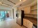 Kitchen with stainless steel refrigerator, granite countertops, and sliding door to brick patio at 40 Dunwoody Springs Dr, Atlanta, GA 30328