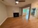 Open-concept living room featuring a fireplace, hardwood floors, and a sliding glass door at 40 Dunwoody Springs Dr, Atlanta, GA 30328
