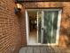 Brick-walled patio with sliding glass door leading into home at 40 Dunwoody Springs Dr, Atlanta, GA 30328