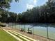 Community tennis courts with benches for spectators and mature trees surrounding at 40 Dunwoody Springs Dr, Atlanta, GA 30328