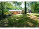 Spacious backyard with a wooden deck and lush greenery, offering privacy and relaxation at 6494 Bimini Dr, Forest Park, GA 30297