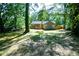 Expansive backyard with a charming deck, surrounded by mature trees for added shade and seclusion at 6494 Bimini Dr, Forest Park, GA 30297
