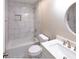 Bright bathroom featuring white marbled walls, a sleek bathtub, and modern fixtures at 6494 Bimini Dr, Forest Park, GA 30297