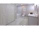 Updated bathroom with marble floors, a soaking tub, and modern fixtures at 6494 Bimini Dr, Forest Park, GA 30297