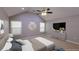 Bright bedroom featuring a ceiling fan and large windows bringing in lots of natural light at 6494 Bimini Dr, Forest Park, GA 30297