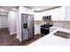 Modern kitchen featuring stainless steel appliances, granite countertops, and white cabinetry at 6494 Bimini Dr, Forest Park, GA 30297