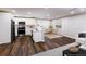Kitchen and dining area with stainless steel appliances, wood floors, and bright lighting at 6494 Bimini Dr, Forest Park, GA 30297