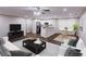 Bright living room open to kitchen with stainless appliances, and hardwood floors at 6494 Bimini Dr, Forest Park, GA 30297
