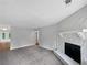 Cozy living room features stone fireplace and soft carpeting at 8332 Mountain Pass, Riverdale, GA 30274